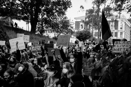 Manifestation féministe avec des participants levant les poings et brandissant des pancartes sur la violence et la solidarité